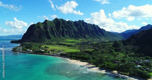 Aerial view flying towards lush jungle mountain landscape on the east side of Oahu in Hawaii 
