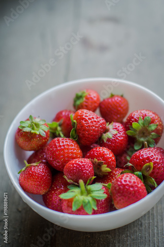 strawberry in a plate on wooden background