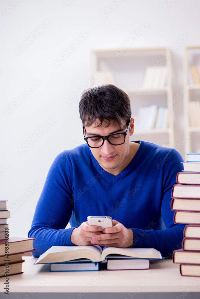 Male student preparing for exams in college library Male student preparing for exams in college library