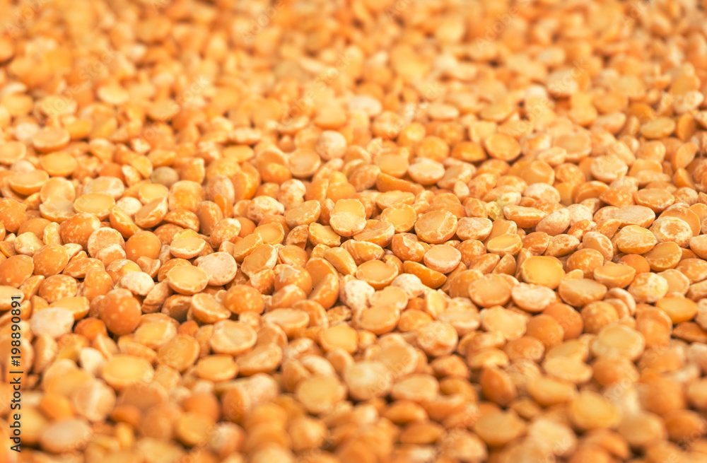 Yellow dry peas background texture, split dried peas closeup Yellow dry peas background texture, split dried peas closeup