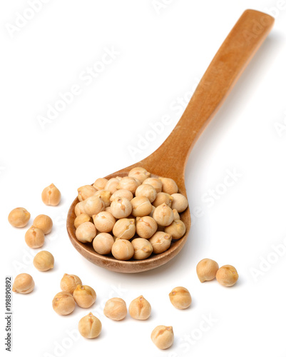 dried chickpeas in the wooden spoon, isolated on white