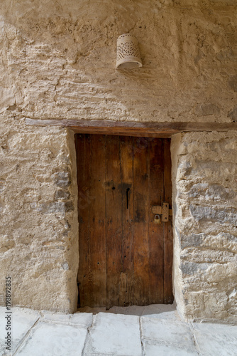 Ancient stone bricks wall and old wooden door at the Monastery of Saint Paul the Anchorite (aka Monastery of the Tigers), Egypt © Khaled El-Adawi
