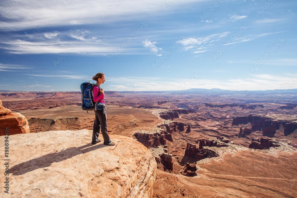 Hiker rests in Canyonlands National park in Utah, USA