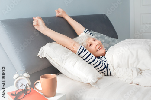 Tableau sur toile Happiness elderly woman woke up in the morning and smiling