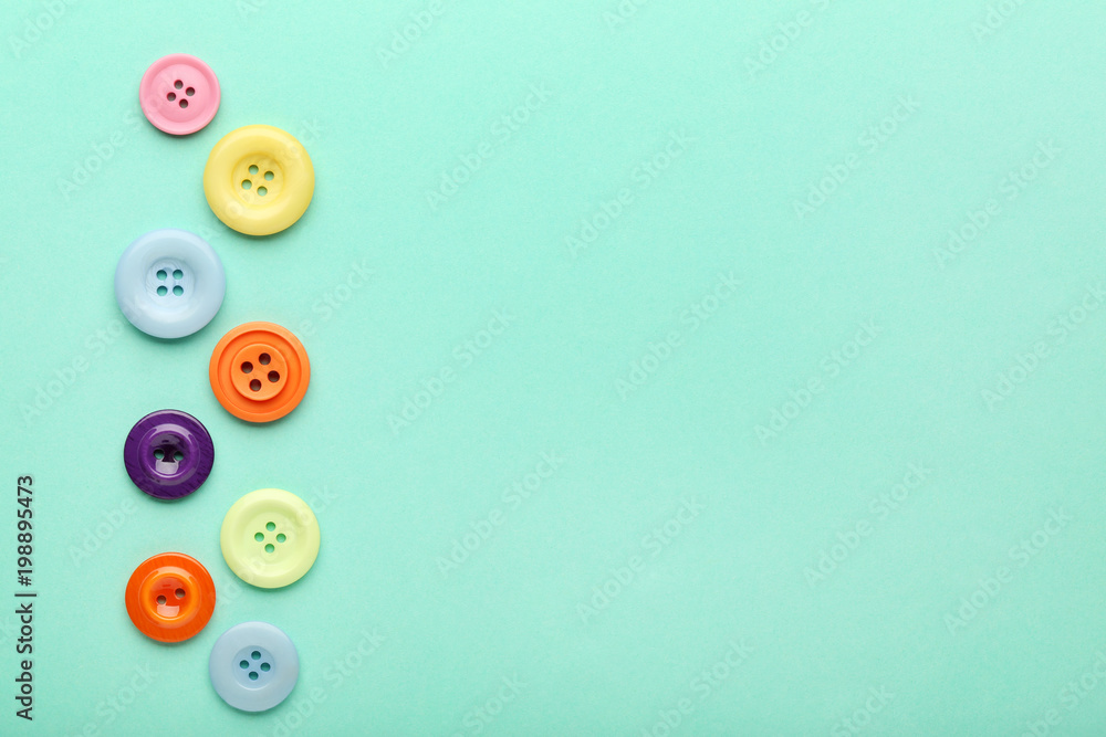 Colorful sewing buttons on mint background Colorful sewing buttons on mint background