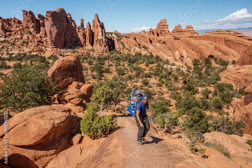 A family with baby son visits Arches National Park in Utah, USA