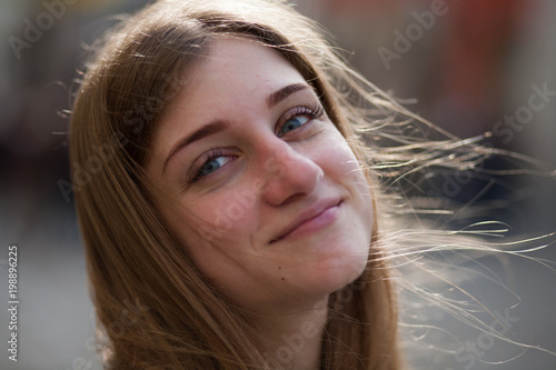 Portrait of a smiling young girl making selfie photo in park