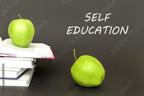 text self education, two green apples, open books with concept photo