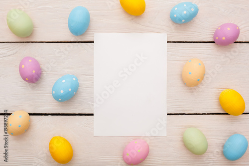 Easter traditional objects isolated on wooden background virtical paper with eggs photo