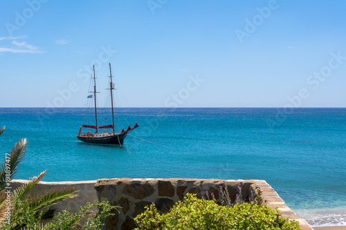 View of ship on blue sea in Paleochori bay on Milos island in Greece. photo