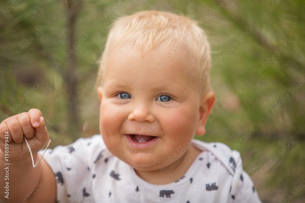 Portrait of a baby boy in green pine forest Portrait of a baby boy in green pine forest