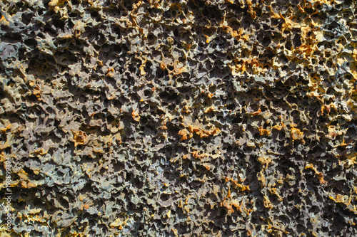 Abstract dark background, natural lava stone texture close up © barmalini