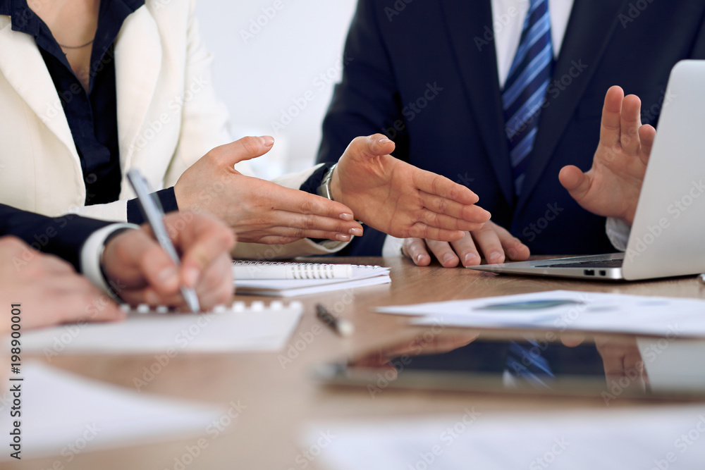 Group of business people or lawyers at meeting, hands close-up Group of business people or lawyers at meeting, hands close-up
