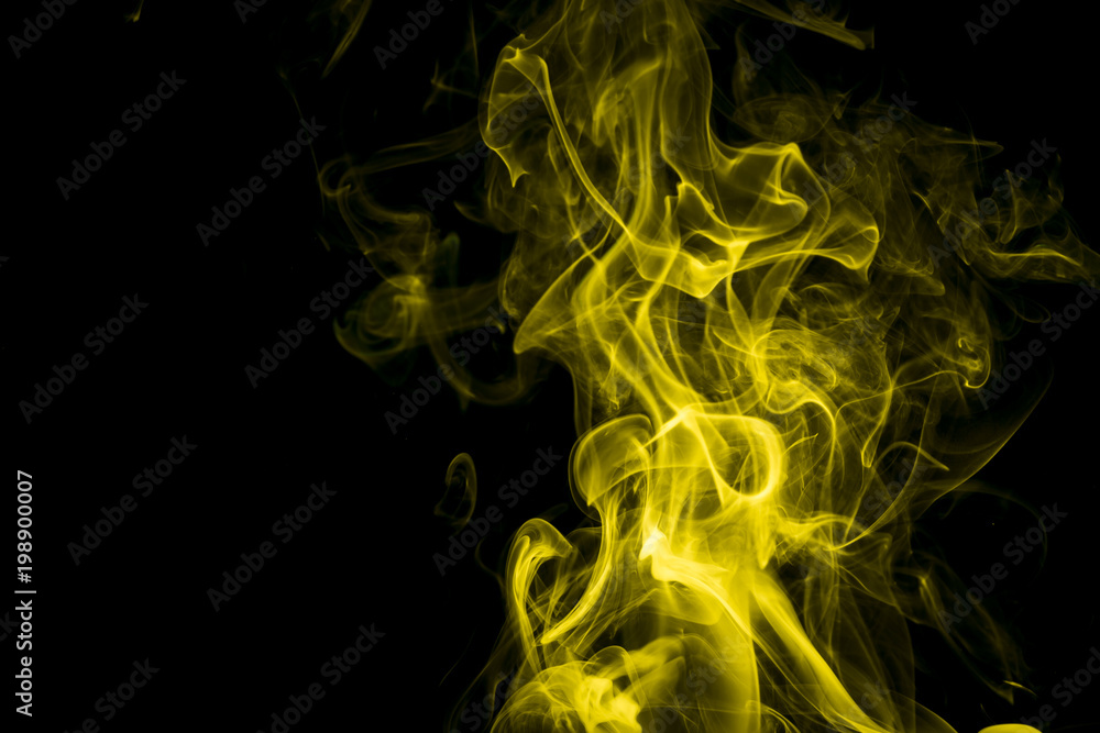 Obraz premium Yellow smoke on black background