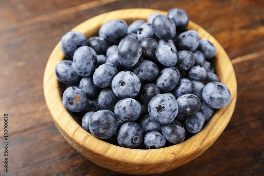 ripe organic bog whortleberry in a wooden plate ripe organic bog whortleberry in a wooden plate