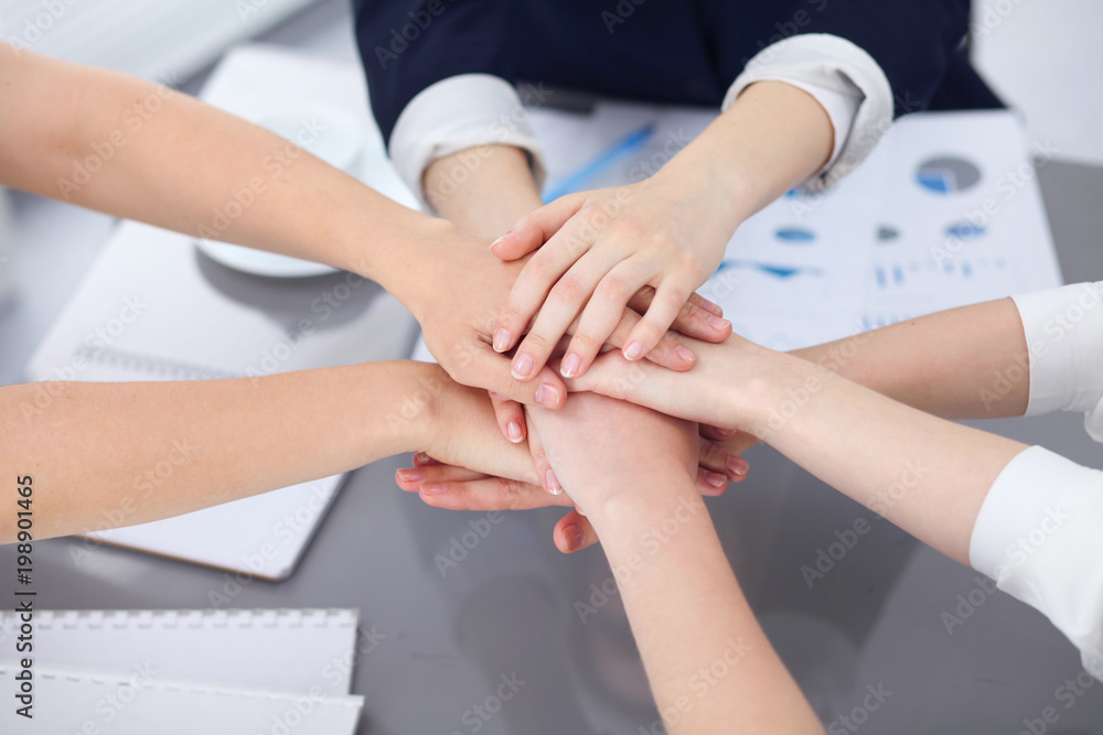 Close Up of unknown business people joining hands. Teamwork, cooperation and success concept of people communication Close Up of unknown business people joining hands. Teamwork, cooperation and success concept of people communication