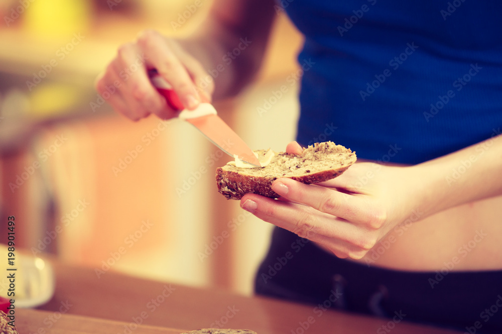 Woman making sandwich cutting bread Woman making sandwich cutting bread