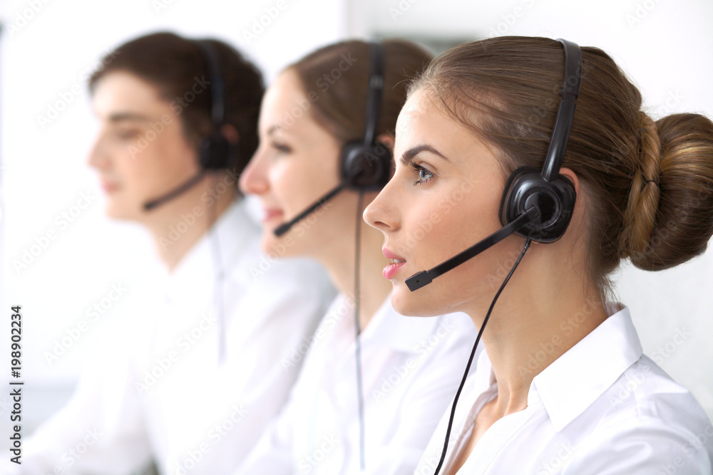 Call center. Focus on beautiful woman in headset Call center. Focus on beautiful woman in headset