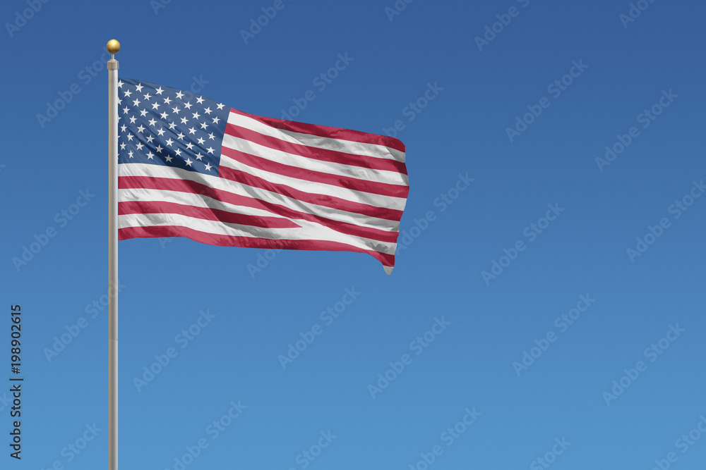 USA Flag of in front of a clear blue sky