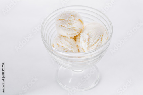 Vanilla ice cream on white background. Scoops of vanilla ice cream in glasses bowl
