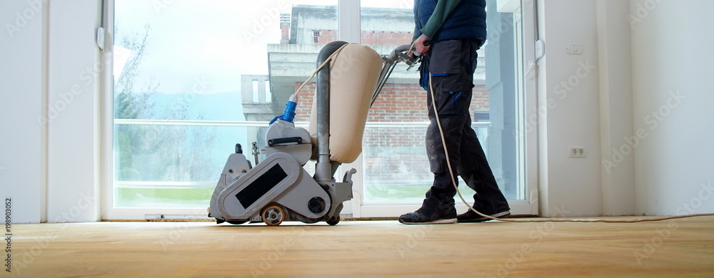 Sanding parquet with the grinding machine. Polishing, repair in apartment - obrazy, fototapety, plakaty 