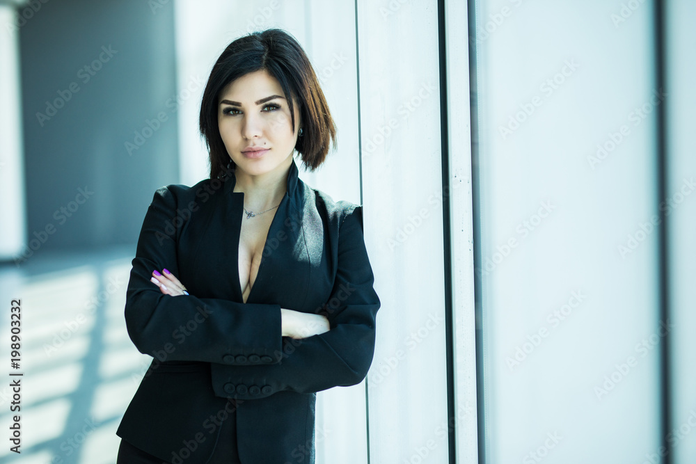Businesswoman crossed hands portrait in office with panoramic windows. Business concept Businesswoman crossed hands portrait in office with panoramic windows. Business concept