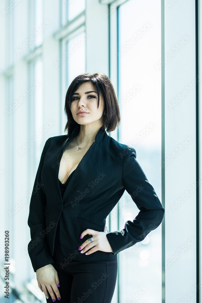 Businesswoman crossed hands portrait in office with panoramic windows. Business concept Businesswoman crossed hands portrait in office with panoramic windows. Business concept
