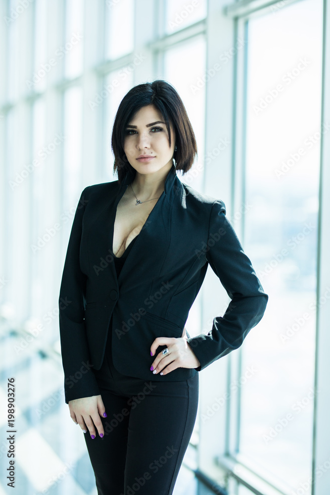 Businesswoman crossed hands portrait in bright office with panoramic windows Businesswoman crossed hands portrait in bright office with panoramic windows