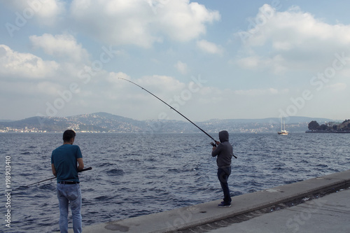 Two fishermen by Bosphorus strait in Tarabya area of Istanbul.