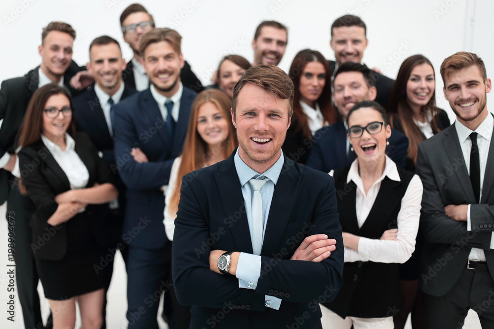 smiling businessman standing on background of her business team. smiling businessman standing on background of her business team.