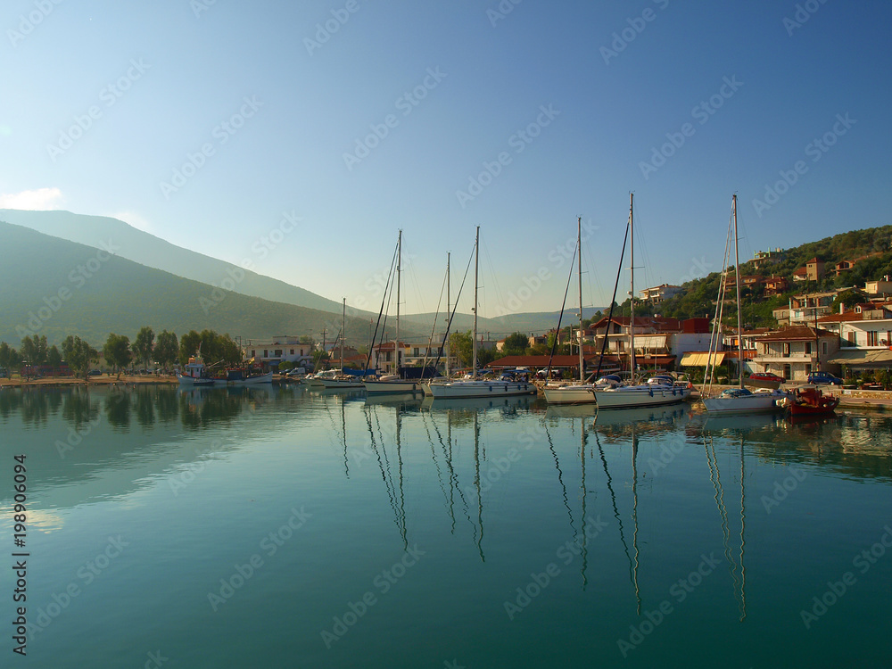 Yachts anchored at sunrise in the harbour in Amaliapoli, Thessaly, Greece