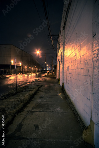 Dark scary city sidewalk at night