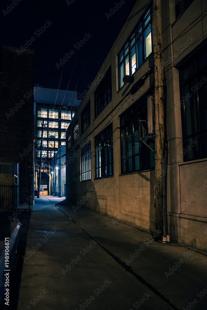 Dark and eerie urban city alley at night.