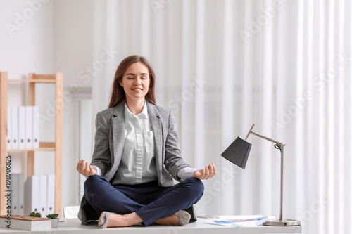 Young woman meditating on t...