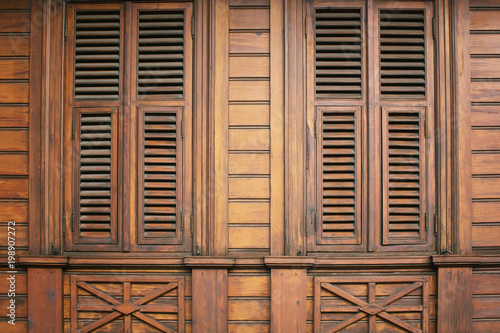 Close up view of old, wooden, decorative closed window shutters.