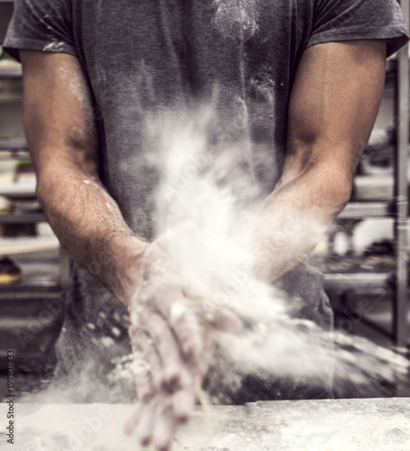 Blurred motion of the man splashing flour,selective focus