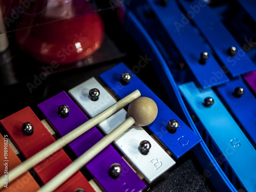 close up toy colourful xylophone instument with sticks on it photo