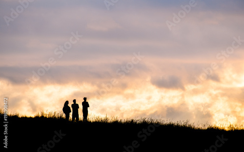 Silhouette scene of a couple enjoy with their drone at sunset on the top of Mt. Eden, Auckland, New Zealand.