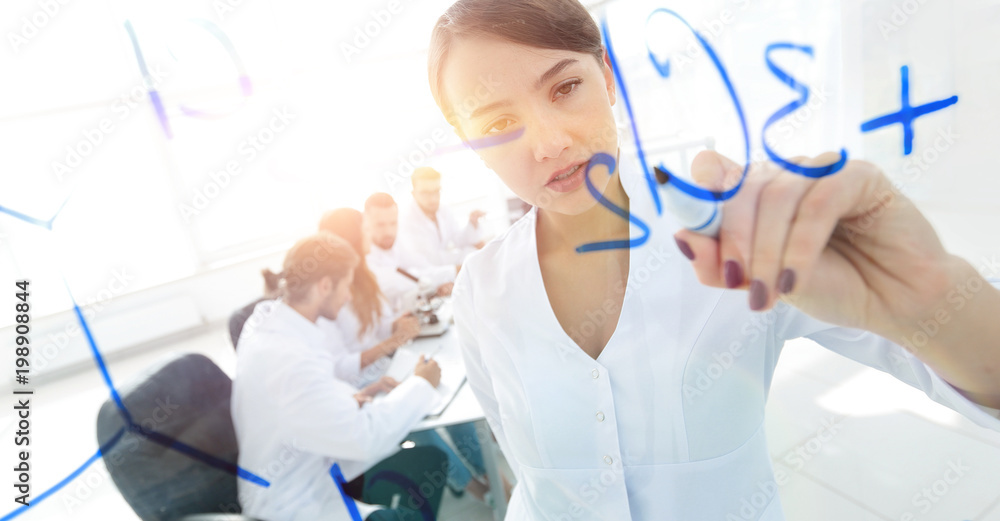 view through the transparent Board. female scientist makes a rep view through the transparent Board. female scientist makes a rep