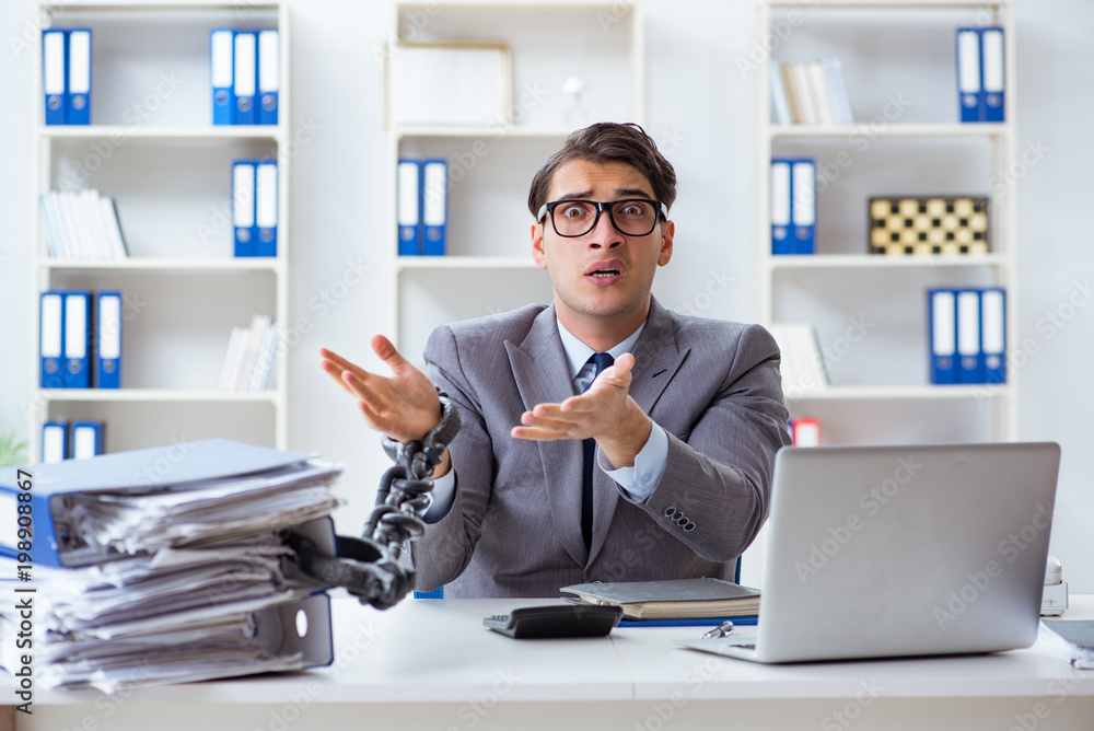 Busy employee chained to his office desk