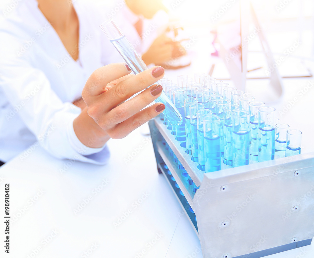 Woman researcher is surrounded by medical vials and flasks Woman researcher is surrounded by medical vials and flasks