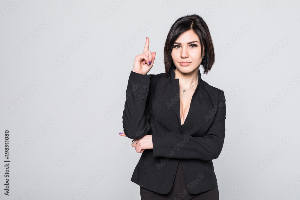 Portrait of young business woman pointing up at white background Portrait of young business woman pointing up at white background