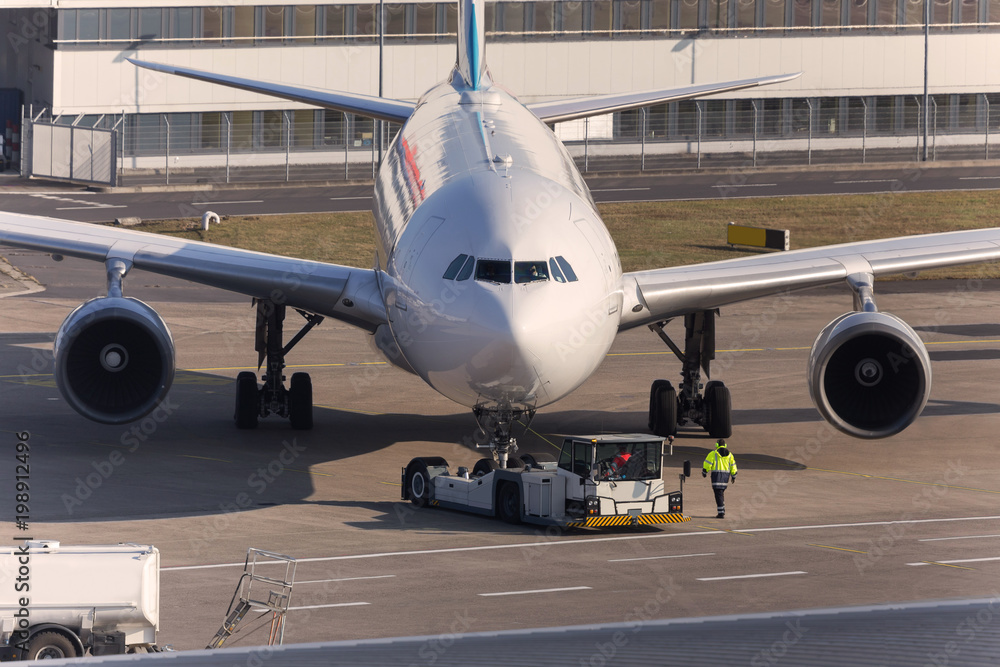 passenger airplane on the ground beeing towed passenger airplane on the ground beeing towed