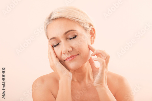 Portrait of beautiful mature woman on light background. Skin care concept