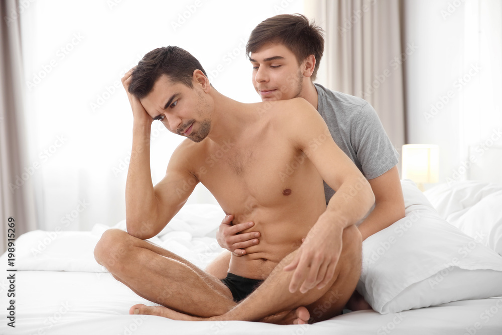 Young gay couple with relationship problems on bed Young gay couple with relationship problems on bed