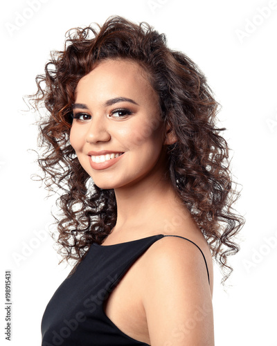 Beautiful young African American woman with long wavy hair on white background