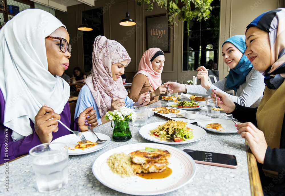 Islamic women friends dining together with happiness Islamic women friends dining together with happiness