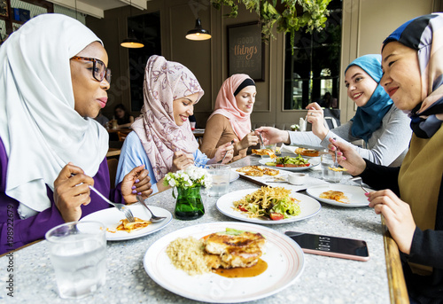 Islamic women friends dining together with happiness