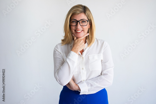 Happy mature Caucasian woman leaning chin on hand. Portrait of successful female business leader or expert for corporate website. Business and advertisement concept