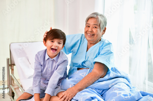 Patient Concept. Grandma s in the hospital. Waiting for someone to visit. Grandchildren visit grandma at the hospital. Grandma is happy to meet grandchildren.